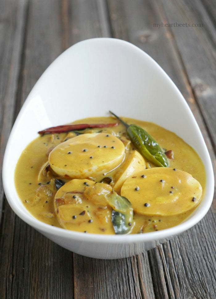 Kerala Egg Curry is a popular south Indian dish made by adding hard-boiled eggs to a spiced coconut milk sauce. Recipe on myheartbeets.com