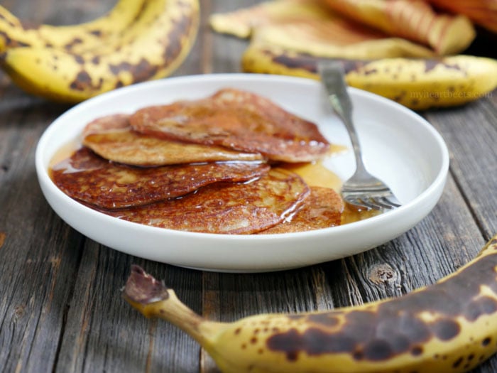 These are gluten-free cardamom spiced banana pancakes - also known as "Banana Malpua" - an Indian dessert. They're light and soft in the middle with crispy edges. Recipe by Ashley of MyHeartBeets.com